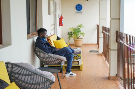 Image of man sitting at BongoHive wit Draper Startup House logo on the background